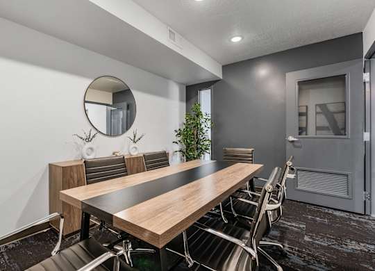 a conference room with a long wooden table and chairs at The Flats at Riverwoods, Provo, Utah