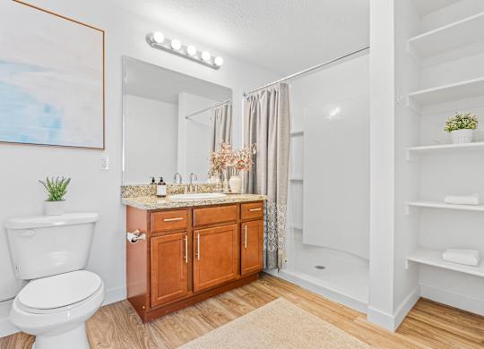 a bathroom with a toilet and a sink and a mirrorat The View on 20th, Ogden