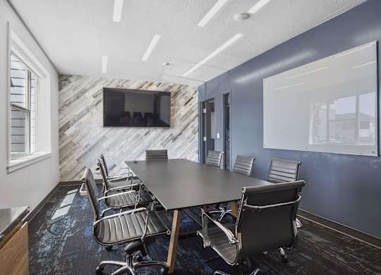 a conference room with a large table and chairs at The Flats at Riverwoods, Provo, 84604