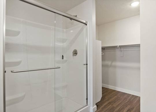 a bathroom with a glass shower stall in a 555 waverly unit at The Flats at Riverwoods, Provo, UT