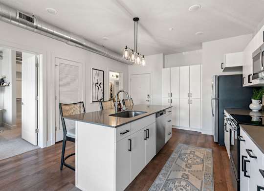an open kitchen and dining area with a large counter top at The Revival, Salt Lake City Utah