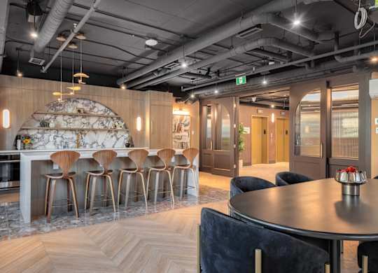 A modern dining area with a round table and chairs.