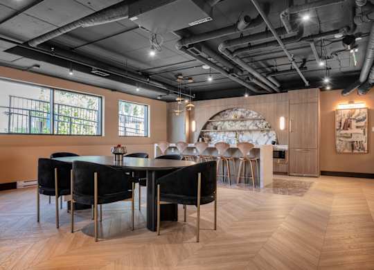 A modern dining room with a large table and chairs.