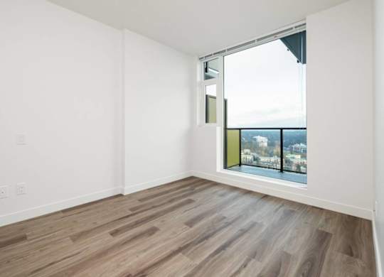 A room with a window overlooking a cityscape.