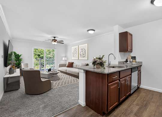 A modern kitchen with dark wood cabinets and a white countertop.