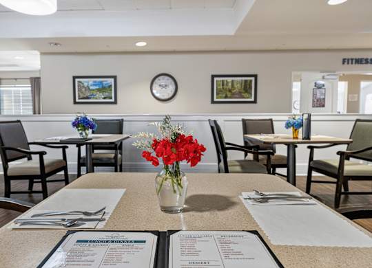 A dining area with tables set for a meal.
