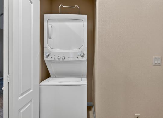 A white toilet with a tank and a white door is in a room.