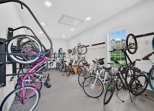 A bike rack full of bicycles in a room.