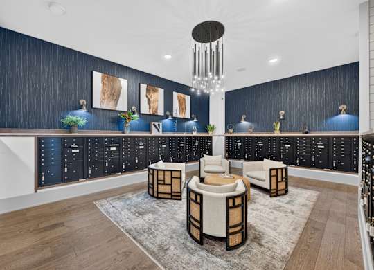 A modern living room with a dark blue accent wall and a white ceiling.