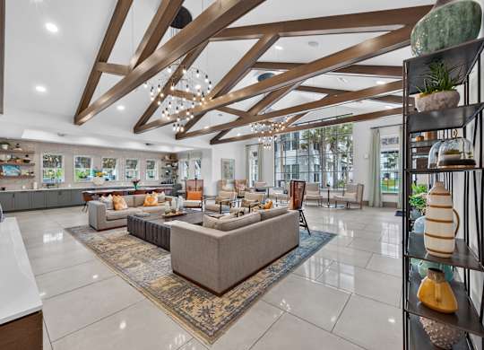 A spacious living room with a large sectional sofa and a rug in the center.