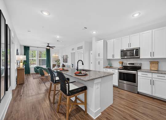A modern kitchen with white cabinets and a center island.