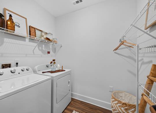 A white laundry room with a washer and dryer.