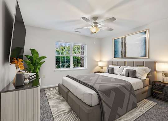 A bedroom with a large bed and a ceiling fan.