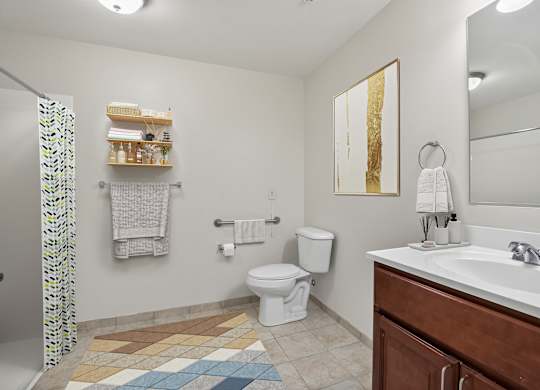 A bathroom with a toilet, sink, and shower curtain.
