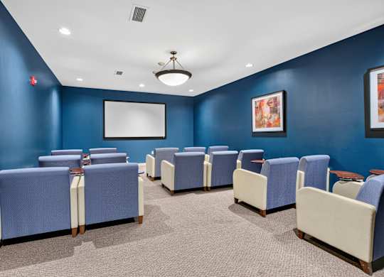 A room with blue walls and a white screen on the wall.