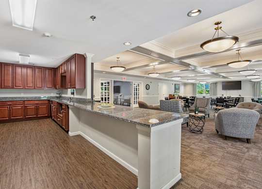 A kitchen with brown cabinets and a white island.