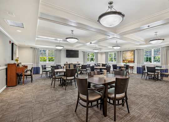 A large conference room with a long table and chairs.
