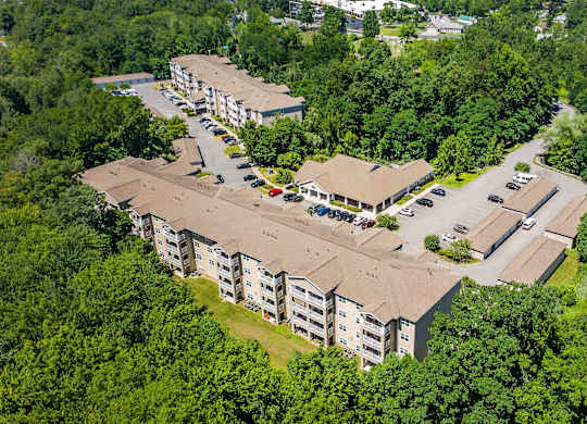 An aerial view of a residential complex surrounded by trees.