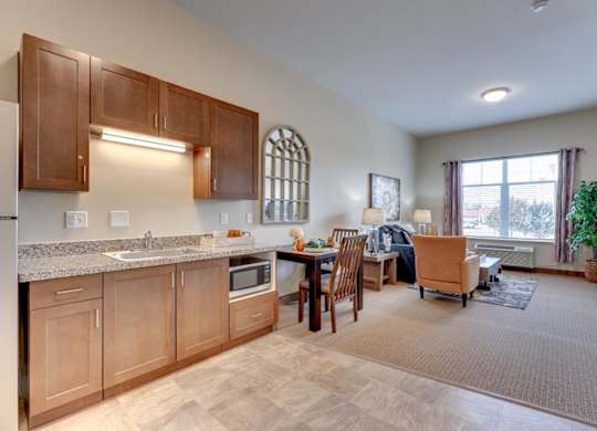 A kitchen with wooden cabinets and a dining table with chairs.