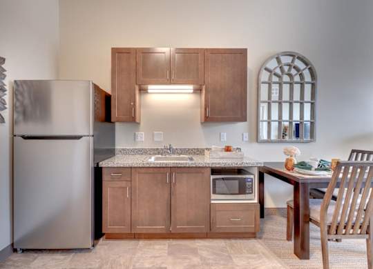 A kitchen with wooden cabinets and a granite countertop.