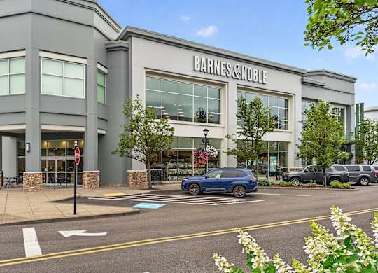 A Barnes & Noble store is shown with a blue car parked in front.