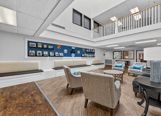 A living room with a couch, chairs, and a coffee table.