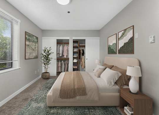 A bedroom with a large bed and a window with blinds.