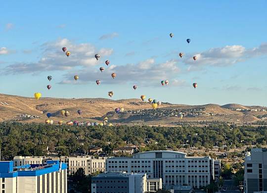 Aerial view of hot air balloons over cityscape at Lakeside Manor Apartments, Reno, Nevada