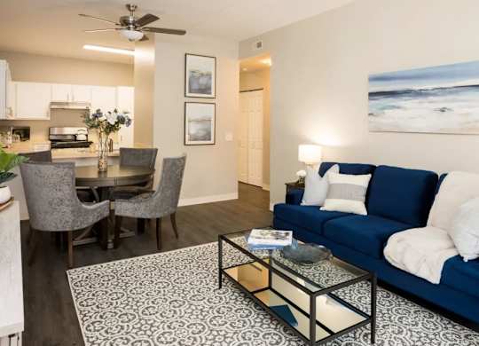 A living room with a blue couch and a coffee table.