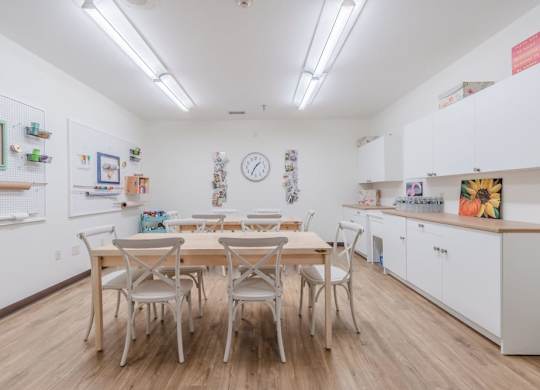 Community kitchen with dining table and chairs at Schuyler Commons Apartments, Utica, 13502