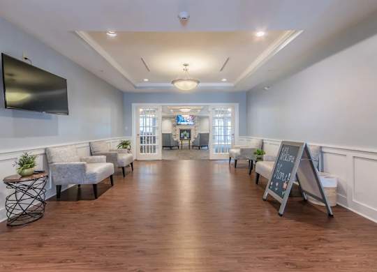 Elegant waiting area with tray ceiling and seating at Glenmont Abbey Village, 55+ Apartments, Glenmont, NJ