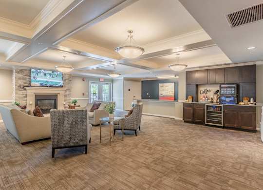 Clubhouse with kitchen area and comfortable seating at Glenmont Abbey Village, 55+ Apartments, Glenmont, New Jersey