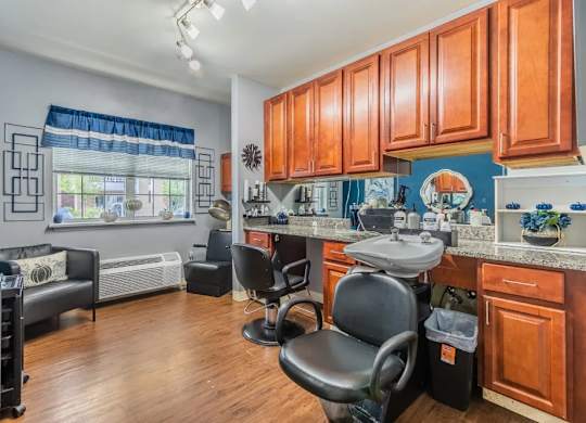 Salon chair with shampoo station and cabinetry at Glenmont Abbey Village, 55+ Apartments, Glenmont, 12077