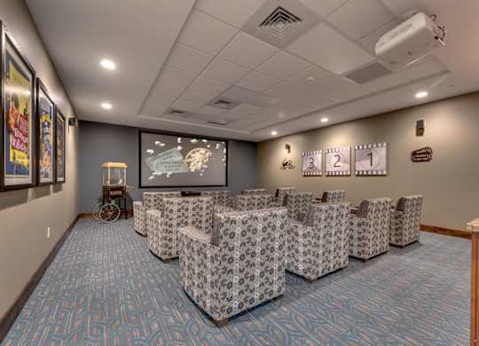 Theater room with stadium seating and projector at Mountain Lakes Estates Apartments, Reno, Nevada