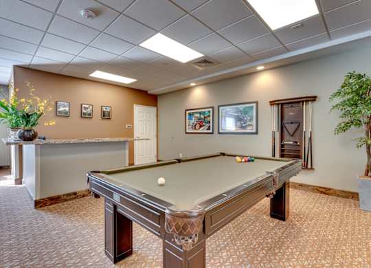 Recreation room with pool table and cue rack at Mountain Lakes Estates Apartments, Nevada