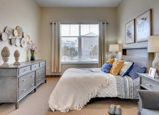 Bedroom with gray furniture and decorative wall art at Mountain Lakes Estates Apartments, Reno, 89521