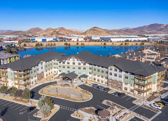 Aerial view of modern apartment complex with lake at Mountain Lakes Estates Apartments, Reno, NV