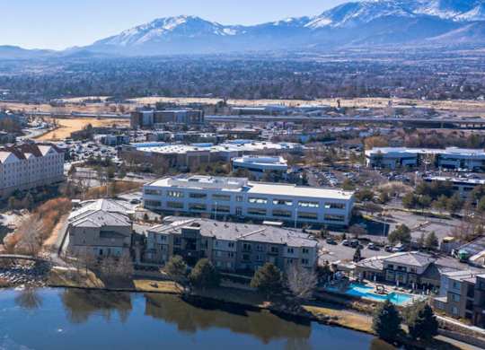 Aerial view of residential buildings with snow capped mountains at Mountain Lakes Estates Apartments, Reno, NV