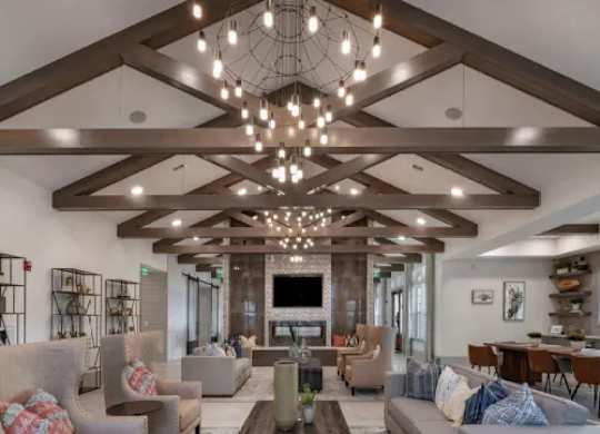A living room with a wooden ceiling and a large sectional sofa. at Atwater at Nocatee Apartments, Toledo, FL, 32081