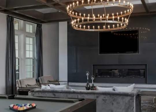 A modern living room with a fireplace and a television. at Atwater at Nocatee Apartments, Florida, 32081