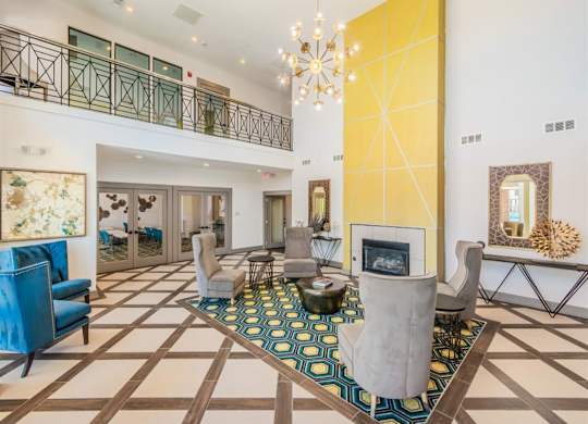 A large, open living room with a fireplace and a chandelier. at The Spring at Silverton Apartments, Fort Worth, 76133
