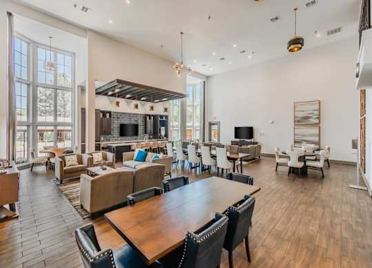 A spacious living room with a fireplace and a dining table. at The Spring at Silverton Apartments, Fort Worth, Texas