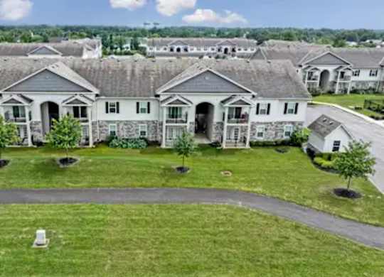 A row of houses with a grassy front yard.
