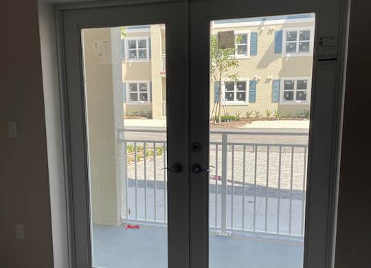 A window with a view of a building across the street.
