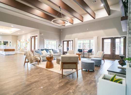 A spacious living room with wooden floors and furniture.