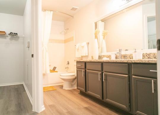 A bathroom with a toilet, sink, and shower.
