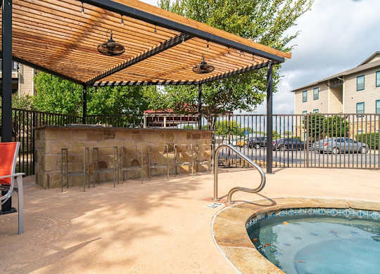 A small pool with a wooden canopy over it.