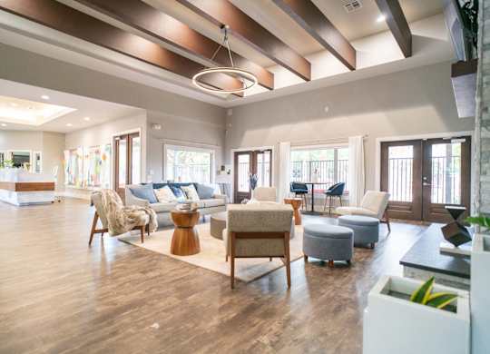 A spacious living room with wooden floors and furniture.