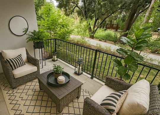 A patio with a sofa, chair, and table.