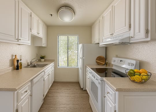 A kitchen with white cabinets and appliances.at Camino Creek, ROHNERT PARK California